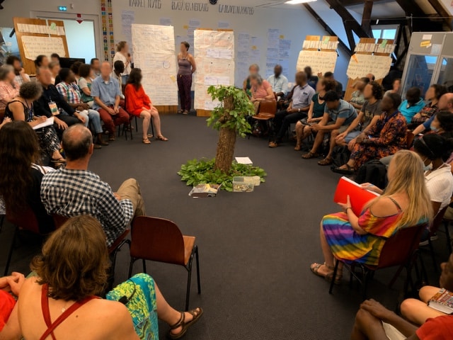 Participantq à un séminaire international eassemblés en cercle pour faire le point sur leurs avancées 